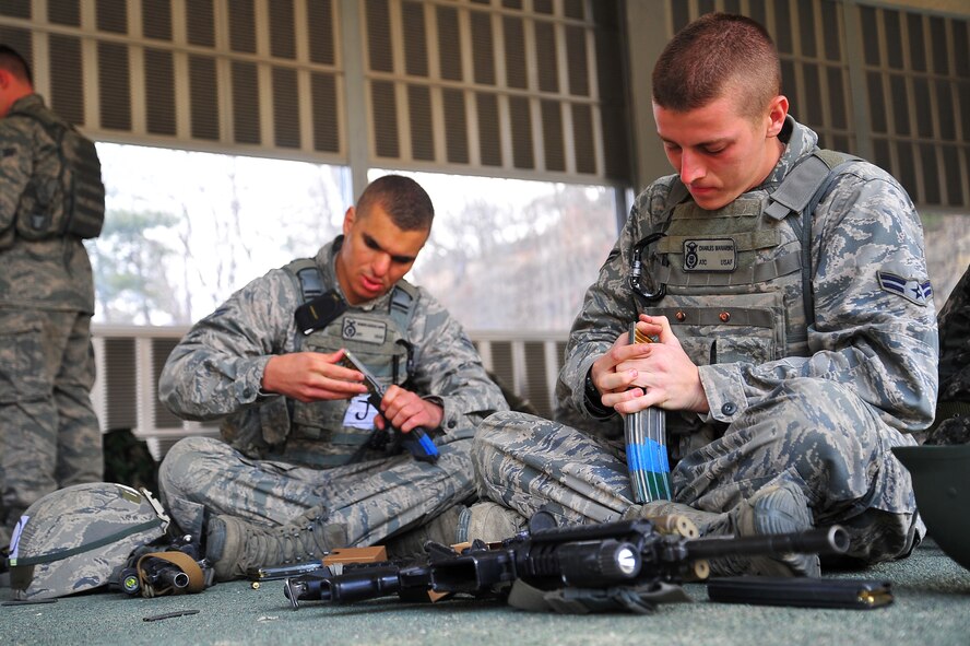 Airman 1st Class Charles Manarino (right) and Airman 1st Class Brandon Almanzar-Harper, 51st Security Forces Squadron members, load up their magazines with live ammunition for a shooting exercise at the Jinjui Air Force Education and Training Command firing range Republic of Korea, March 7, 2013.  The 10 SFS members chosen to attend the joint training were handpicked by their leadership in order to go through the course. (U.S. Air Force photo/Staff Sgt. Emerson Nuñez)