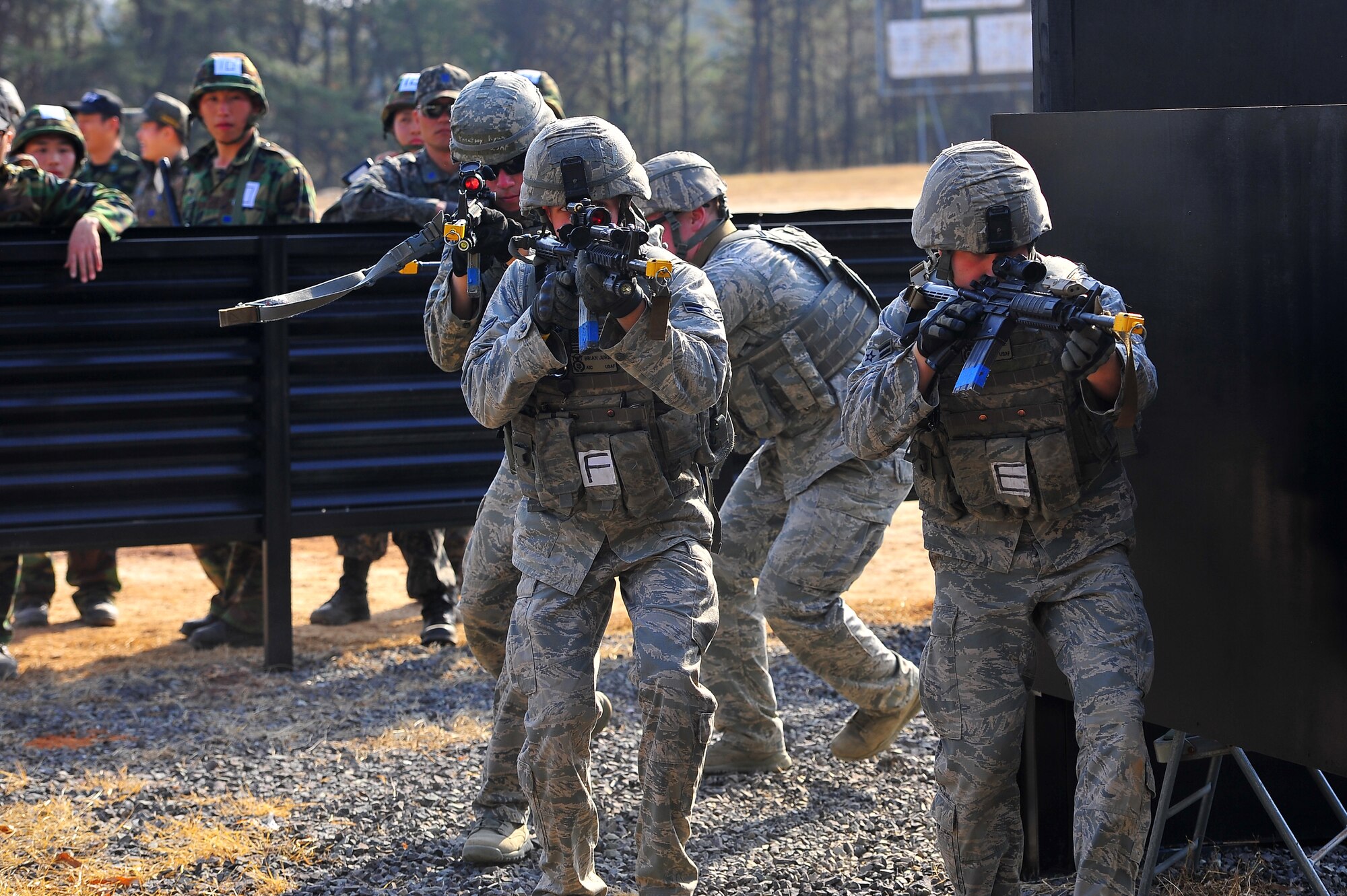 Airmen with the 51st Security Forces Squadron demonstrate how to clear out a building at the Jinjui Air Force Education and Training Command Republic of Korea, March 6, 2013.  51st SFS members learned how to clear Korean buildings, known for being close in proximity to each other, during course. (U.S. Air Force photo/Staff Sgt. Emerson Nuñez)