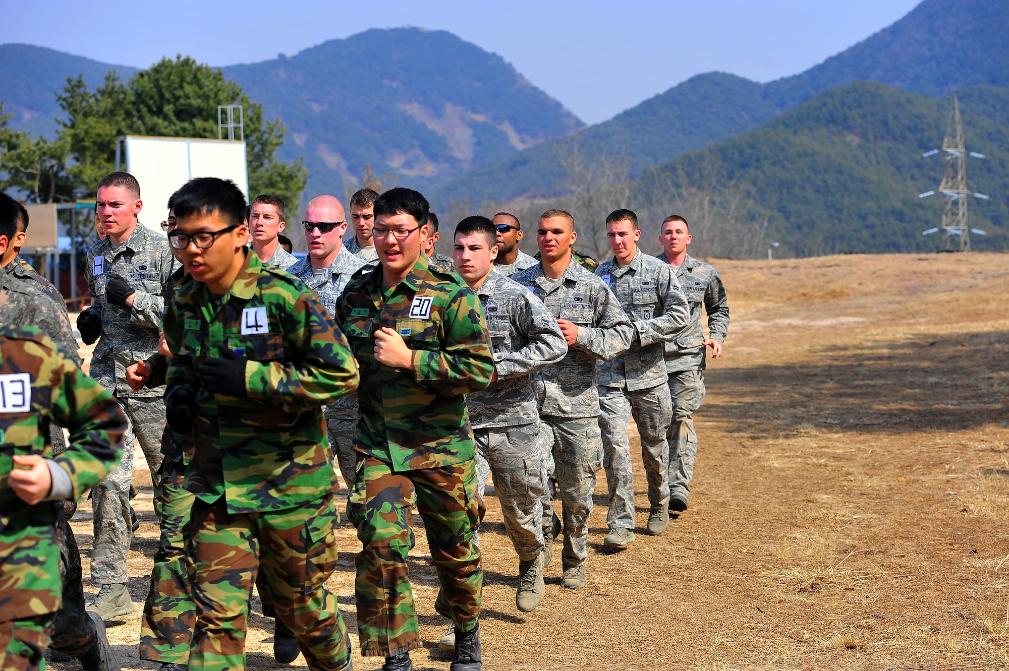 Members from the Republic of Korea Air Force air police and 51st Security Forces Squadron warm up before their second physical training session of the day at the Jinjui Air Force Education and Training Command ROK, March 6, 2013.  Physical training is an important aspect to the air police special duty team course and is a key part of their overall day.  (U.S. Air Force photo/Staff Sgt. Emerson Nuñez)