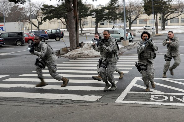 U.S. Air Force Airmen from the 35th Security Forces Squadron and 35th Civil Engineer Squadron respond to a simulated active shooter at the Exchange during the Pacific Air Forces High Risk Response Training course at Misawa Air Base, Japan, March 8, 2013. The course provided effective response tactics to empower first responders to eliminate an active shooter or other high-risk response threats. (U.S. Air Force photo by Tech. Sgt. Marie Brown)