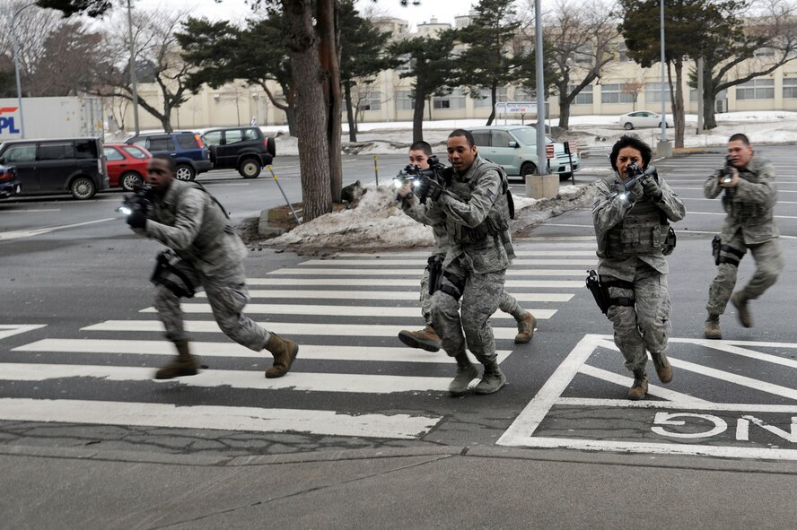 U.S. Air Force Airmen from the 35th Security Forces Squadron and 35th Civil Engineer Squadron respond to a simulated active shooter at the Exchange during the Pacific Air Forces High Risk Response Training course at Misawa Air Base, Japan, March 8, 2013. The course provided effective response tactics to empower first responders to eliminate an active shooter or other high-risk response threats. (U.S. Air Force photo by Tech. Sgt. Marie Brown)
