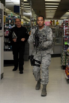 Jon Mulcahy, Mission Security Division mobile training team instructor, evaluates U.S. Air Force Staff Sgt. Gqwon Morton, 35th Security Forces Squadron, as he searches the base exchange for a simulated active shooter during a Pacific Air Forces High Risk Response Training course at Misawa Air Base, Japan, March 8, 2013. The course is a five-day program of instruction based on real-life scenarios that help prepare first responders for unpredictable situations. (U.S. Air Force photo by Tech. Sgt. Marie Brown) 