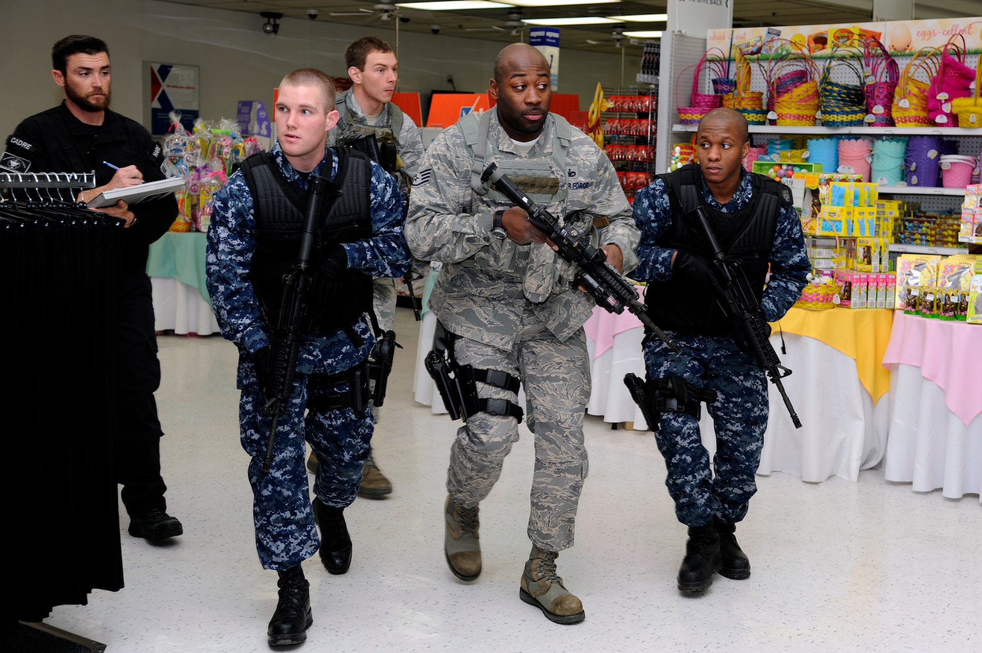 Tyler Hare, left, Mission Security Division mobile training team instructor, evaluates Airmen and Sailors response to a simulated active shooter at the Exchange during the Pacific Air Forces High Risk Response Training course at Misawa Air Base, Japan, March 8, 2013. Airmen from the 35th Security Forces Squadron, 35th Civil Engineer Squadron and Sailors from Naval Air Facility Misawa participated in the five-day course. (U.S. Air Force photo by Tech. Sgt. Marie Brown)
