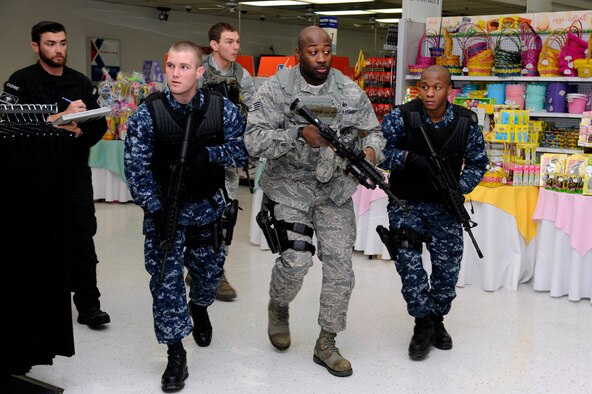 Tyler Hare, left, Mission Security Division mobile training team instructor, evaluates Airmen and Sailors response to a simulated active shooter at the Exchange during the Pacific Air Forces High Risk Response Training course at Misawa Air Base, Japan, March 8, 2013. Airmen from the 35th Security Forces Squadron, 35th Civil Engineer Squadron and Sailors from Naval Air Facility Misawa participated in the five-day course. (U.S. Air Force photo by Tech. Sgt. Marie Brown)