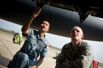 U.S. Air Force Senior Airman Corey Henry, right, an F-15C Eagle armament technician, talks with a Republic of Singapore Air Force F-15SG maintainer as they participate in an F-15 aircraft maintenance exchange between U.S. and RSAF aircraft maintainers during Cope Tiger 13 at Korat Royal Thai Air Force Base, Thailand, March 12, 2013. Crew chiefs, avionics specialists and quality assurance inspectors from each nation discovered common ground in their vital link to generate the flying mission as look over U.S. Air Force F-15s and the RSAF's variatn - the F-15SG. Henry is assigned to the 44th Aircraft Maintenance Unit at Kadena Air Base, Japan. More than 300 U.S. service members are participating in CT13, which offers an unparalleled opportunity to conduct a wide spectrum of large force employment air operations and strengthen military-to-military ties with two key partner nations, Thailand and Singapore. (U.S. Air Force photo/2nd Lt. Jake Bailey)