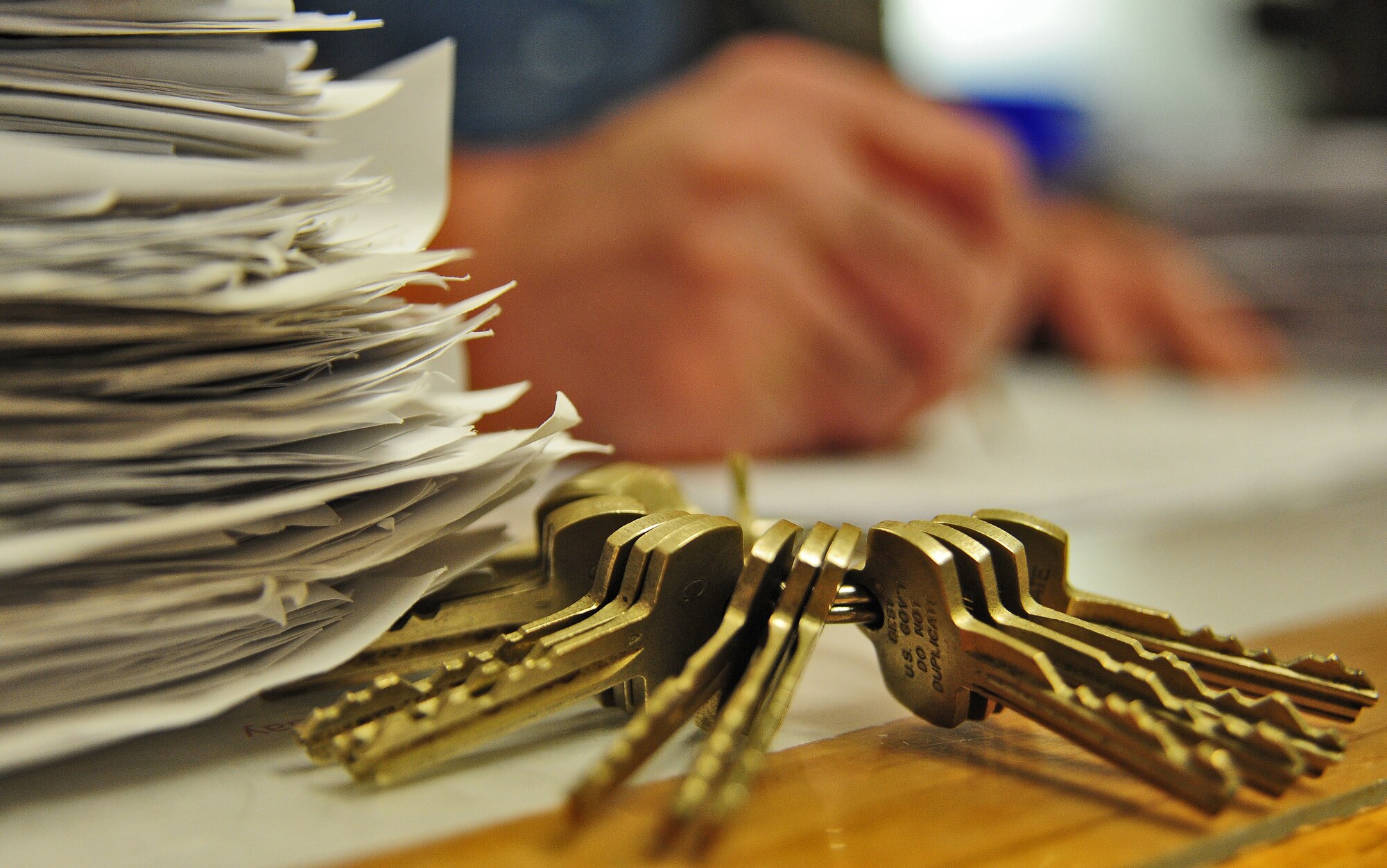 WHITEMAN AIR FORCE BASE, Mo. -- Jack Crain, 509th Civil Engineer Squadron locksmith, inspects a stack of job orders, March 6. Team Whiteman’s locksmiths are accountable for more than 1,200 job orders each year. (U.S. Air Force photo/Staff Sgt. Nick Wilson) (Released)