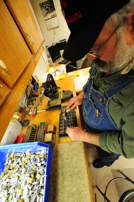 WHITEMAN AIR FORCE BASE, Mo. -- Jack Crain, 509th Civil Engineer Squadron locksmith, hammers pinning codes into a key, Mach 6. Different series of numbers help prevent the duplication of keys and maintain the continuity of locks. (U.S. Air Force photo/Staff Sgt. Nick Wilson) (Released) 