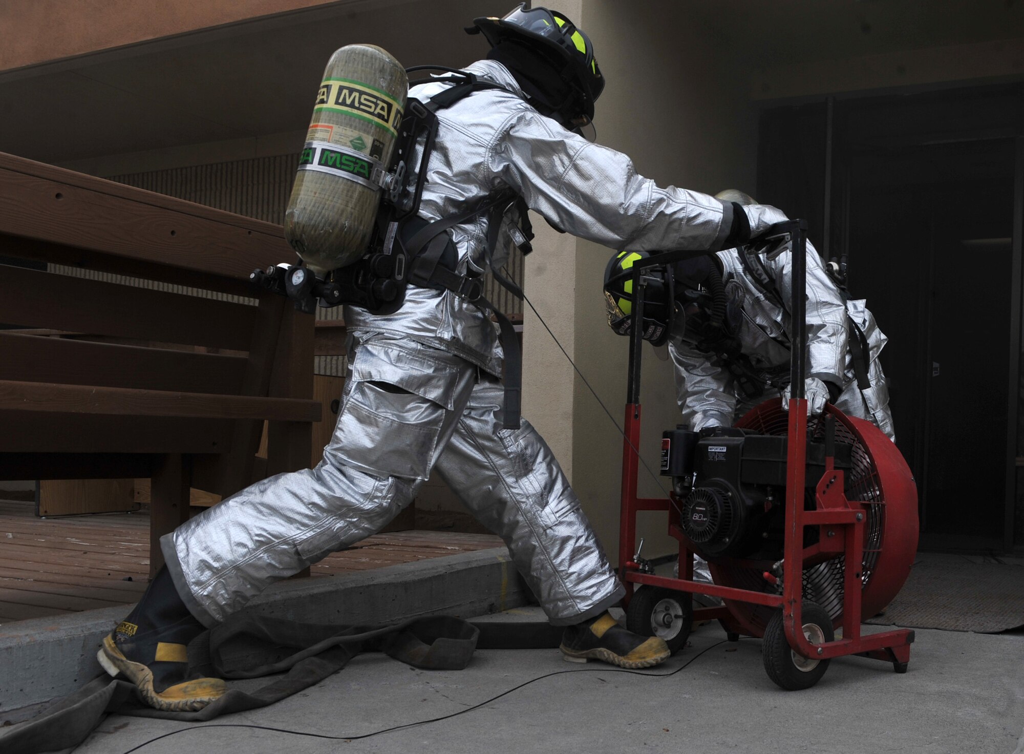U. S. Air Force Airmen from the 366th Civil Engineer Squadron try to get a fan working to clear out the smoke from a simulated fire, March 6, 2013, at Mountain Home Air Force Base, Idaho. During an Operation Readiness Exercise, each unit is challenged on the knowledge of different procedures. (U.S. Air Force photo/Senior Airman Heather Hayward)