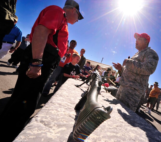 LAS VEGAS, Nev. – A 99th Ground Combat Training Squadron combat arms instructor speaks to an Indian Springs resident about the combat capabilities of the M240 machine gun during Indian Springs Appreciation Day, March 12. The annual open house showcases various Air Force missions to members of the Indian Springs community. (U.S. Air Force photo by Staff Sgt. A.D./Released)