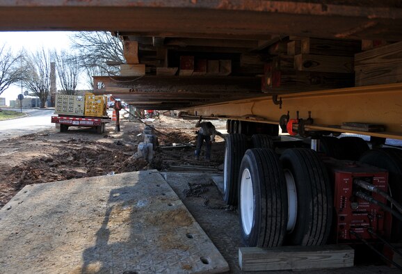 Personnel from Hercules House Movers work to create a path through the mud underneath the Dobbins Air Reserve Base chapel on Mar. 8, in preparation to move it to the Army National Guard side of the base. The Dobbins chapel is scheduled to be moved to the Army National Guard side of the base on Mar. 17. (U.S. Air Force photo/Senior Airman Elizabeth Van Patten)