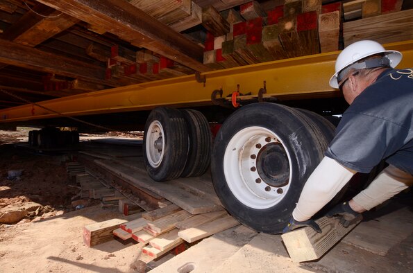 Moving crews use blocks of wood as chalks during the first movement of the Dobbins Air Reserve Base chapel, Mar. 8. (U.S. Air Force photo/Don Peek)