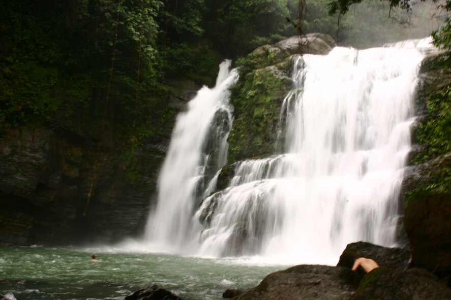 The Nauyaca Waterfalls, Platanillo, Costa Rica, is a favorite spot of toursits as pictured here Jan. 1, 2011.  On that date, Capt. Matt Adams, 647th Air Base Group, witnessed another officer fall from a 25-foot cliff, on the right side of the waterfall, landing on the rocks below and hitting his head and back before sinking to the bottom of a pool below the waterfall.  With complete disregard for his own safety, he dove from the same cliff and over the boulders below to swim down 20 feet to the bottom of the pool where he located the unconscious victim and transported him to shore. Adams was awarded the Airman's medal for his heroism. (U.S. Air Force courtesy photo)