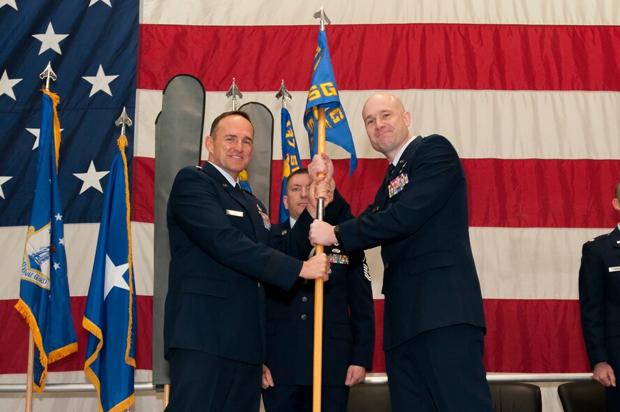 Air National Guard Brig. Gen. Trulan Eyre, 140th Wing Commander, hands the 233d Space Group flag to Col. Gregory T. White, the newly appointed 233d Space Group Commander, during the 233d Space Group Activation Ceremony, March 10, 2013, Greeley Air National Guard Station, Greeley, Colo.  The 137th Space Warning Squadron reorganized as the 233d Space Group and will continue to operate under the 140th Wing, performing the one-of-a-kind Mobile Ground System mission that these men and women have been doing since 1996.  (Air National Guard photo by Tech. Sgt. Wolfram M. Stumpf)