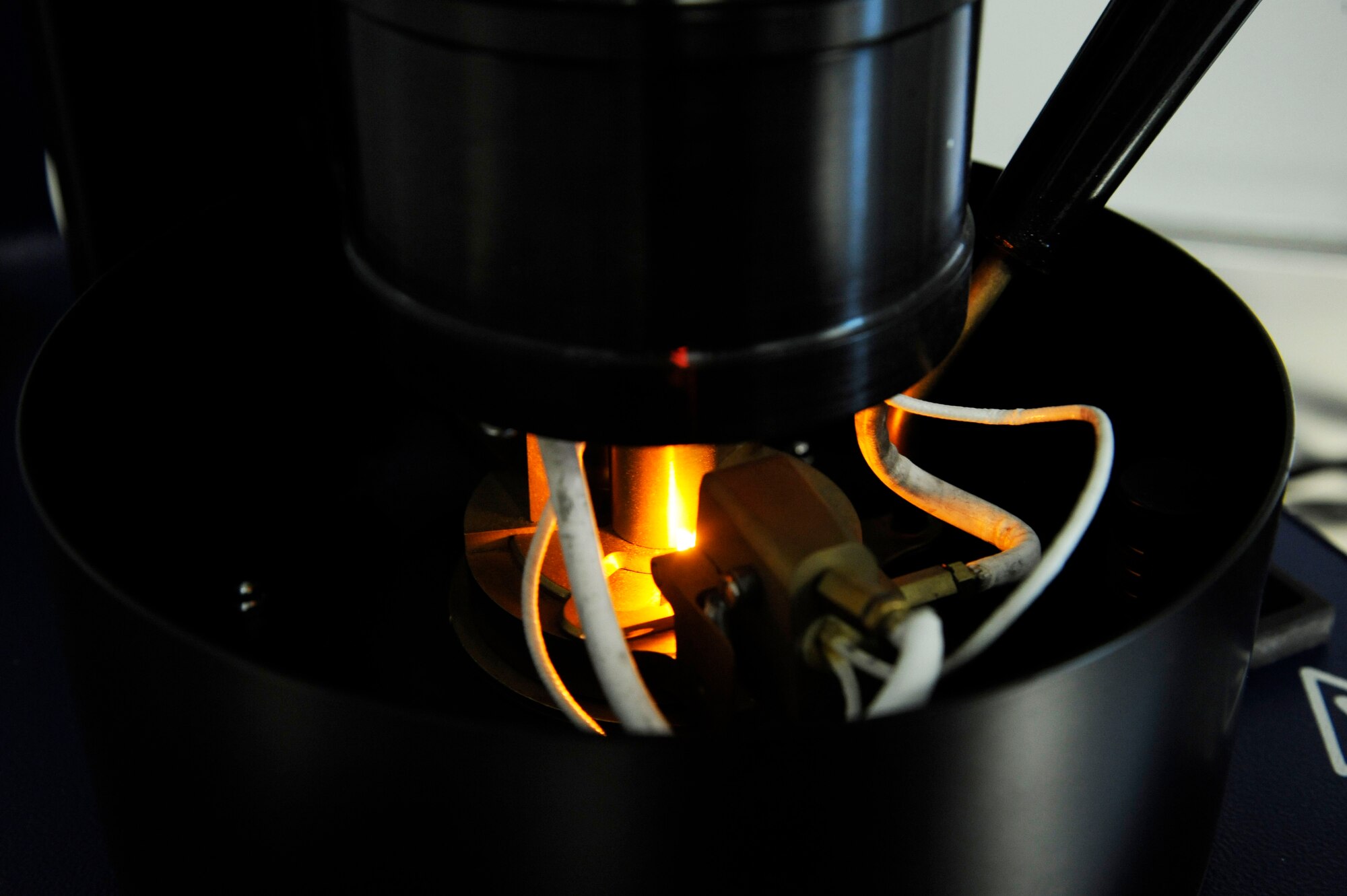 A flashpoint tester heats up JP-8 during a fuel flashpoint test on Barksdale Air Force Base, La., March 13. JP-8 has a flashpoint of 38 degrees Celsius, the tester heats up a sample of fuel to determine if the fuel ignites at the proper flashpoint. (U.S. Air Force photo/Airman 1st Class Andrew Moua)