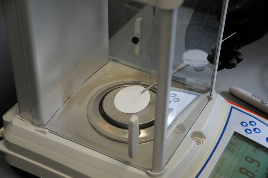 Tech. Sgt. Eric Summarell, 403rd Logistics Readiness Squadron fuels laboratory, weighs filters used for sampling fuel on Barksdale Air Force Base, La., March 13. The filters are weighed before and after testing. The initial weight is compared with the end weight and the difference determines the amount of particulates within the fuel. (U.S. Air Force photo/Airman 1st Class Andrew Moua)
