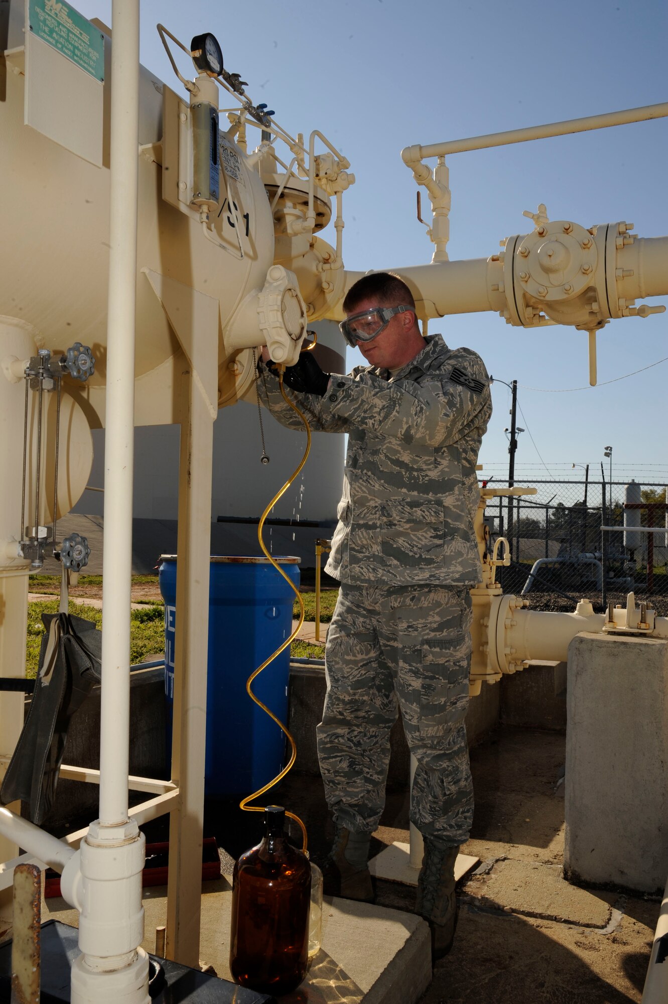 Tech. Sgt. Eric Summarell, 403rd Logistics Readiness Squadron fuels laboratory technician, retrieves a fuel sample for testing on Barksdale Air Force Base, La., March 13. The fuels laboratory tests and samples a variety of different fuels ranging from diesel, jet and missile fuel, and test for contaminants and foreign particles. (U.S. Air Force photo/Airman 1st Class Andrew Moua)