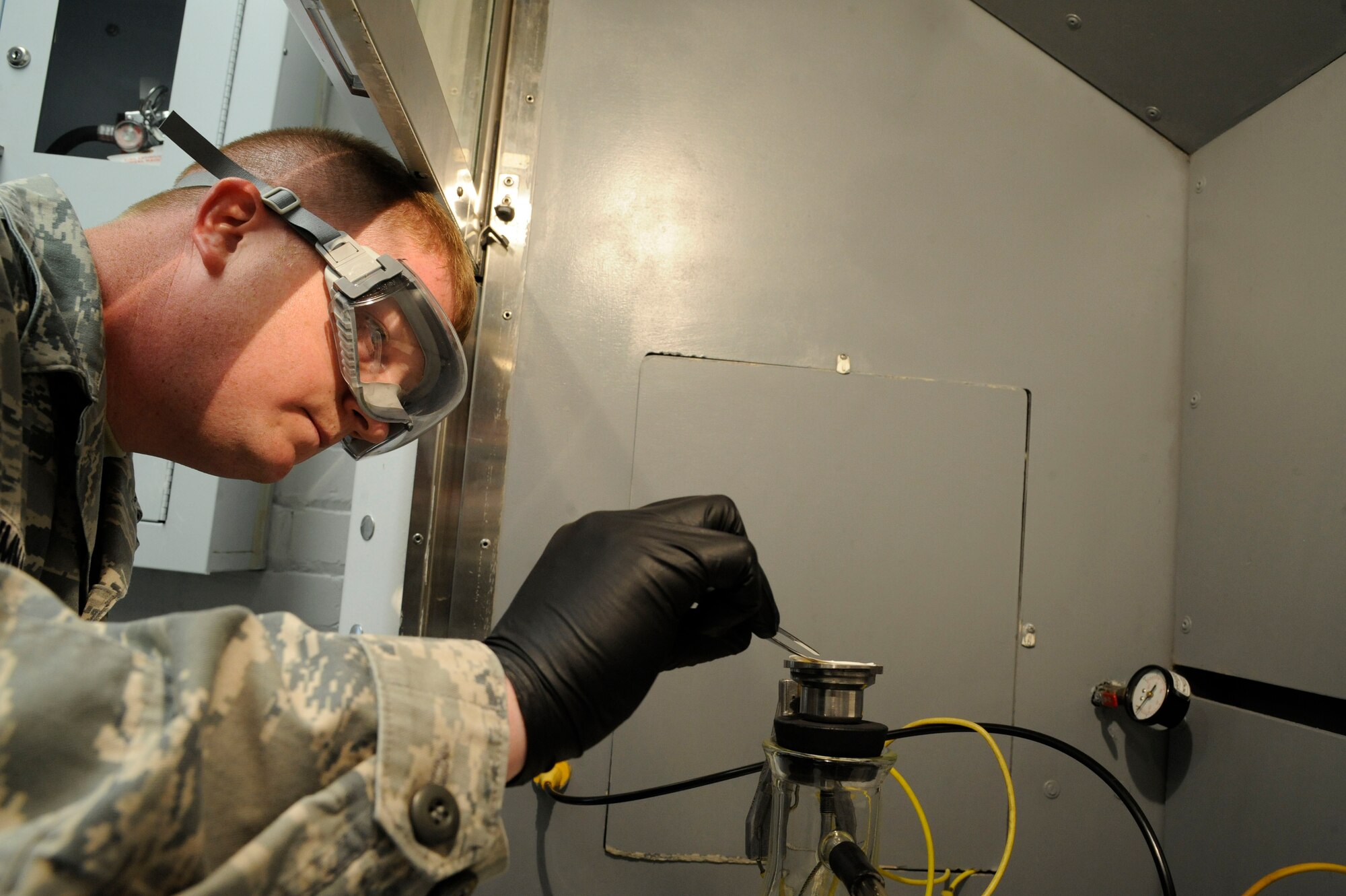 Tech. Sgt. Eric Summarell, 403rd Logistics Readiness Squadron fuels laboratory technician, places filters on a beaker prior to testing fuel samples on Barksdale Air Force Base, La., March 13. The fuels laboratory tests and samples a variety of different fuels ranging from diesel, jet and missile fuel, and test for contaminants and foreign particles. (U.S. Air Force photo/Airman 1st Class Andrew Moua)