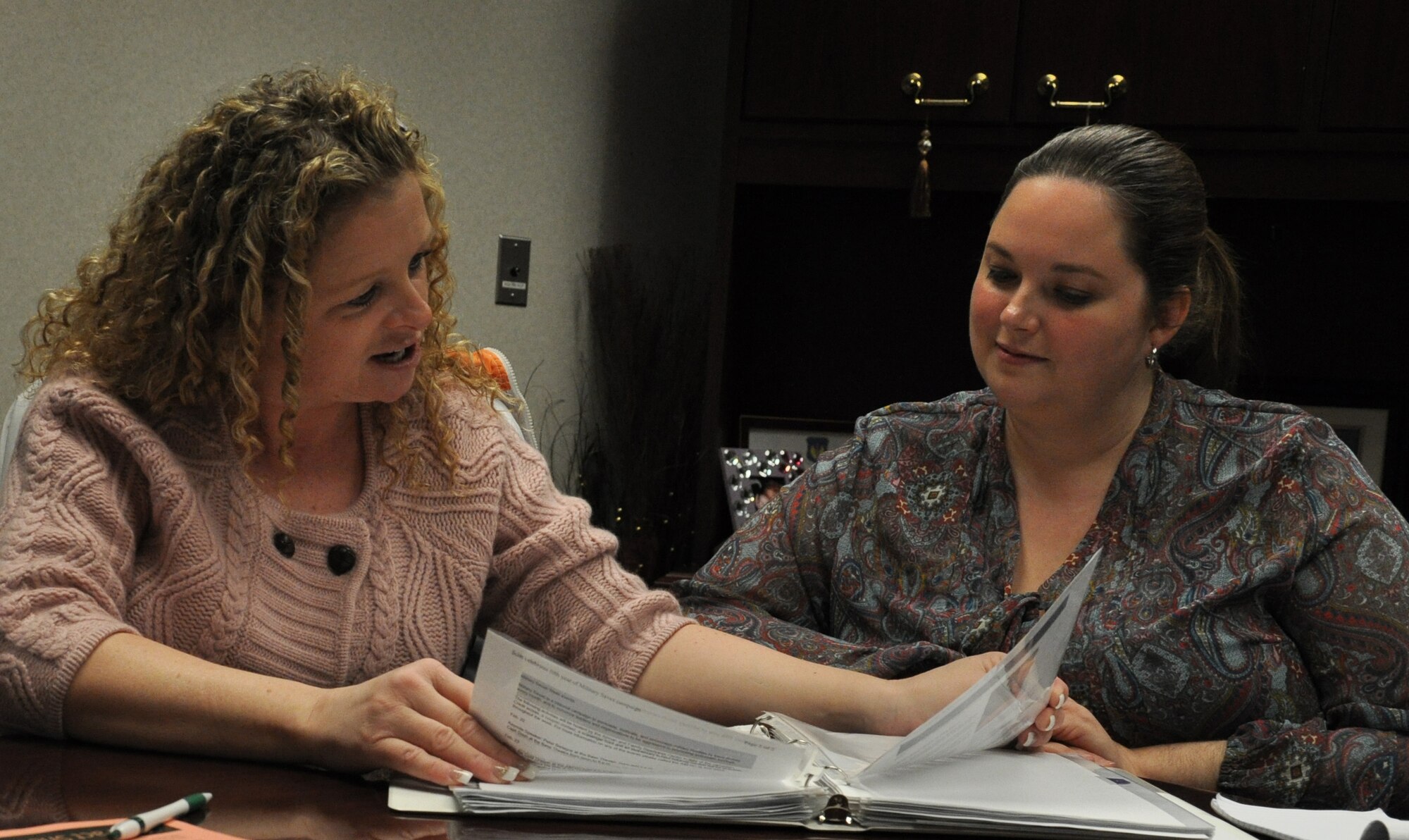 Lona Berndt, 375 Force Support Squadron community readiness consultant, discusses financial worksheets with Kimberly Love, a military family life consultant. The Airman and Family Readiness Center offers financial counseling with newcomer’s classes, information workshops and one on one sessions to servicemembers and their families. (U.S. Air Force photo/Airman 1st Class Jake Eckhardt)