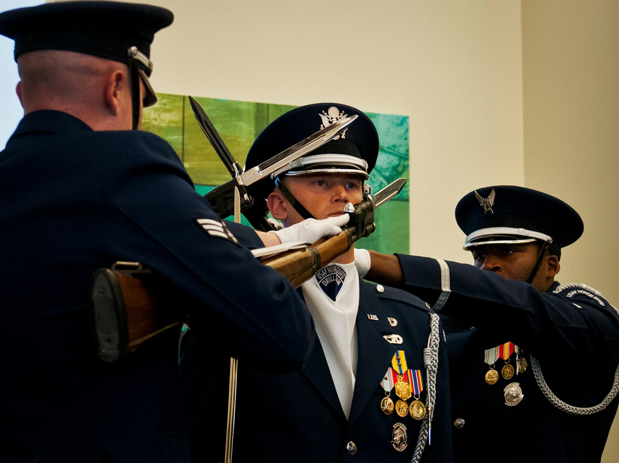 1st Lt. Michael Lemorie, of the Air Force Honor Guard, stands at attention as bayonets fly past his face during the team’s performance March 12 at Eglin Air Force Base, Fla.  The team visited the base to highlight their program and find interested Airmen who may be interested in joining.  After the performance, the group spoke about the requirements to become a member and answered questions from the audience.  (U.S. Air Force photo/Samuel King Jr.)