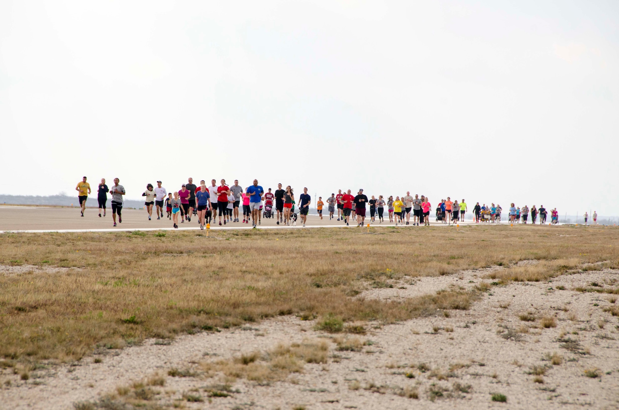 A crowd of runners taking part in the Devil Dash 5K run and walk down the flight line at Laughlin Air Force Base, Texas, March 9, 2013. The Devil Dash 5K was organized by the 434th Flying Training Squadron’s booster club in support of the Wounded Warriors Project. (U.S. Air Force photo/Wes Hough)