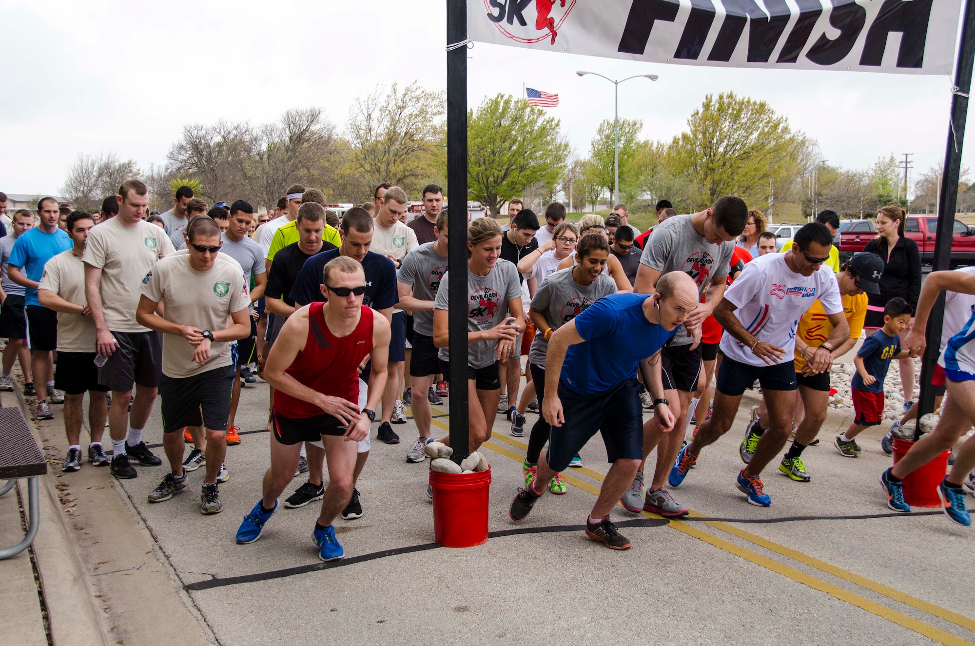 Runners take off from the starting line at the Devil Dash 5K run and walk in front of the Jarvis building at Laughlin Air Force Base, Texas, March 9, 2013. The Devil Dash 5K was organized by the 434th Flying Training Squadron’s booster club in support of the Wounded Warriors Project. (U.S. Air Force photo/Wes Hough)