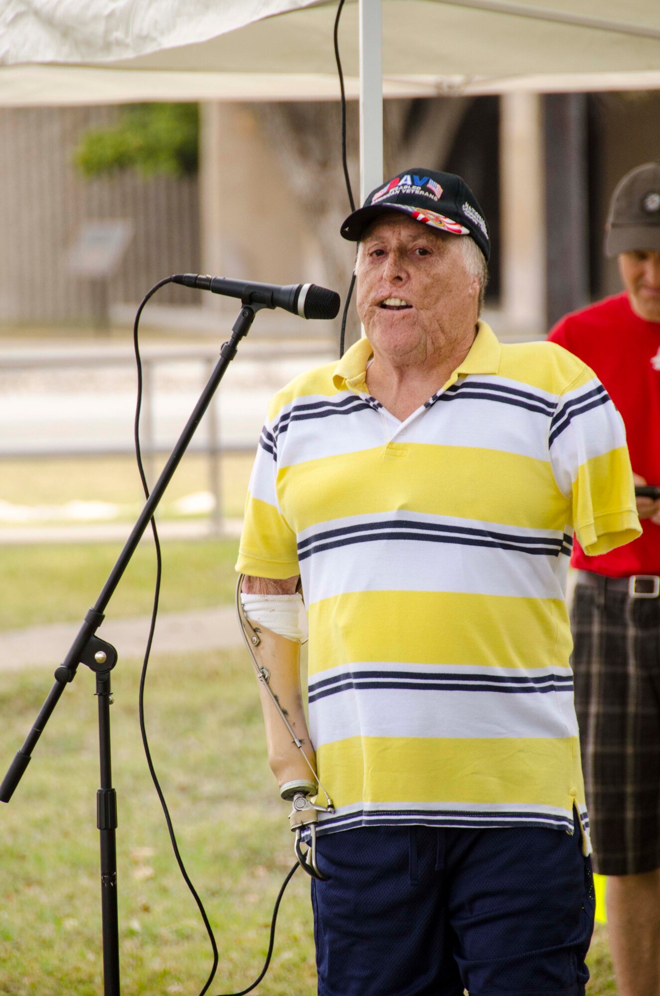 Bobby Barrera, a Marine Corps veteran who was critically wounded in Vietnam, speaks at the opening ceremony for the Devil Dash 5K run and walk in front of the Jarvis Building at Laughlin Air Force Base, Texas, March 9, 2013. The Devil Dash 5K was organized by the 434th Flying Training Squadron’s booster club in support of the Wounded Warriors Project. (U.S. Air Force photo/Wes Hough)