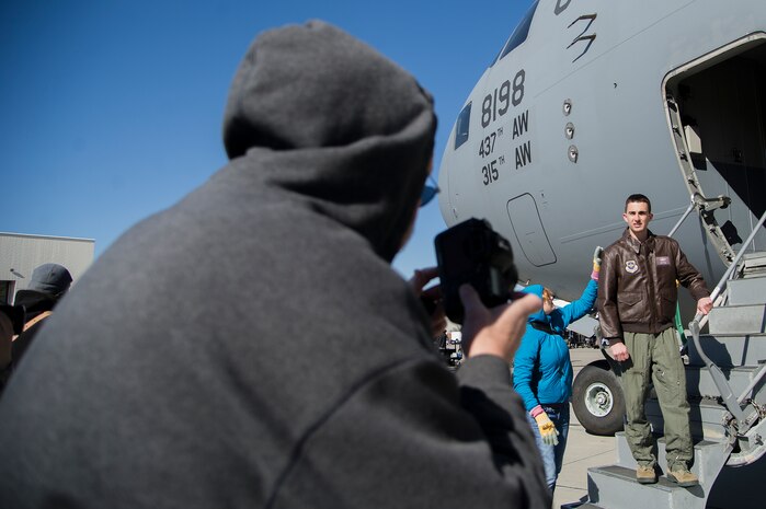 A photographer for the Army Wives television crew photographs Capt. Matt Van Osterom,16th Airlift Squadron pilot, during a break in filming Feb. 28, 2013, at Joint Base Charleston - Air Base, S.C. Van Osterom’s photo will be used in the television show to reference a character’s late husband.  Army Wives tells the story of four women and one man who are brought together by their common bond - they all have military spouses. The series is based on the book "Under the Sabers: The Unwritten Code of Army Wives" by Tanya Biank and is produced by ABC Television Studio and The Mark Gordon Company. (U.S. Air Force photo/ Staff Sgt. Rasheen Douglas) 
