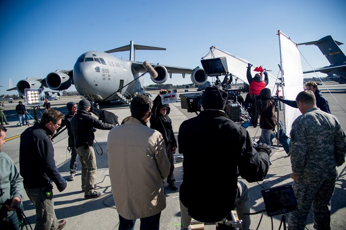 An Army Wives television crew member holds up a clapperboard, a tool used to sync sound and film and to mark specific scenes, to begin filming during an on-location filming session Feb. 28, 2013, at Joint Base Charleston - Air Base, S.C. Army Wives tells the story of four women and one man who are brought together by their common bond - they all have military spouses. The series is based on the book "Under the Sabers: The Unwritten Code of Army Wives" by Tanya Biank and is produced by ABC Television Studio and The Mark Gordon Company. (U.S. Air Force photo/ Staff Sgt. Rasheen Douglas) 
