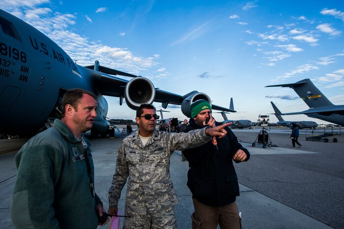 Lt. Col. Francisco Hamm, Air Force Entertainment Liaison Office director, and Master Sgt. Eric Ragan, 437th Aircraft Maintenance Squadron production superintendent, work with an Army Wives film crew member to help accurately portray the Air Force during an on-location filming session Feb. 28, 2013, at Joint Base Charleston - Air Base, S.C. Army Wives tells the story of four women and one man who are brought together by their common bond - they all have military spouses. The series is based on the book "Under the Sabers: The Unwritten Code of Army Wives" by Tanya Biank and is produced by ABC Television Studio and The Mark Gordon Company. (U.S. Air Force photo/ Senior Airman George Goslin)