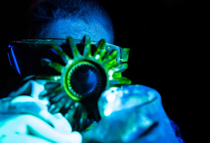Staff Sgt. John Price, 437th Maintenance Squadron non-destructive inspector, uses various dyes, ultraviolet lights and X-rays to inspect aircraft parts without causing any damage to the parts. The 437th MXS NDI shop inspects metal objects ranging from nuts and bolts, to large hooks and sheets of metal. (U.S. Air Force photo/Senior Airman Dennis Sloan)