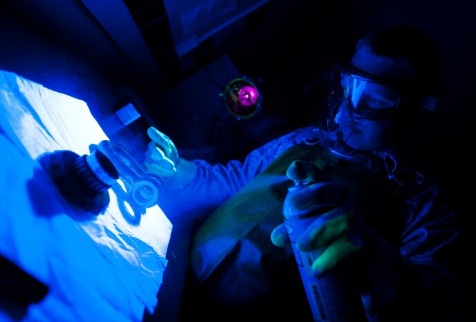 Staff Sgt. John Price, 437th Maintenance Squadron non-destructive inspector, applies a florescent magnetic particle bath spray on a aircraft parts March 8, 2013, at Joint Base Charleston – Air Base, S.C. After the dye dries, the part is placed under ultraviolet lights to reveal cracks or flaws in the metal. The inspection process can take up to an hour for each part, and also includes three separate chemical baths and a drying machine. (U.S. Air Force photo/Senior Airman Dennis Sloan)