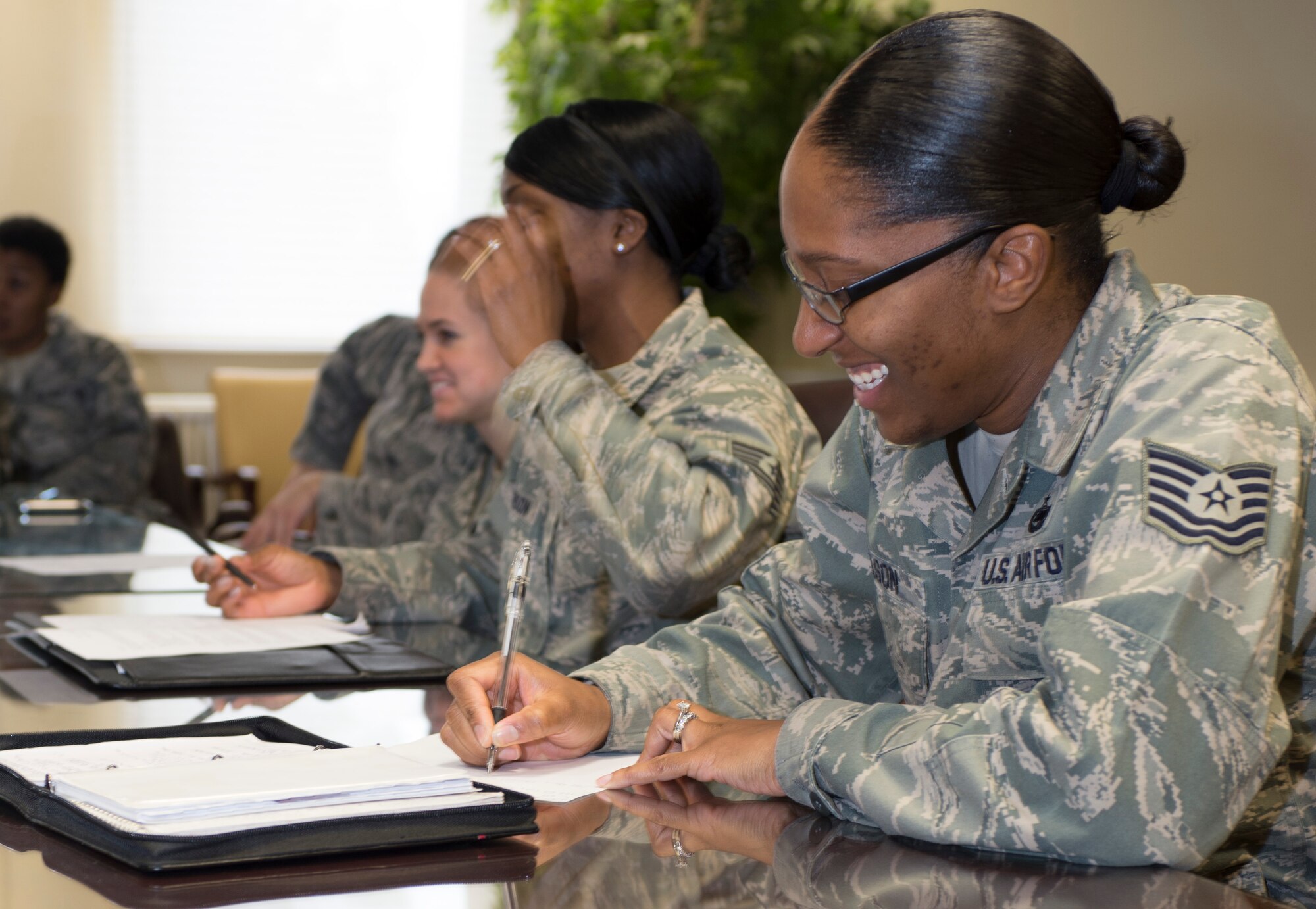 SPANGDAHLEM AIR BASE, Germany -- Tech. Sgt. Victoria Wilson, Pitsenbarger Airman Leadership School instructor from Detroit, takes notes at a SpangDamen women’s success forum brain-storming meeting March 7, 2013 at the Spangdahlem conference room. The women’s is an outreach program designed by military women for military women of all ranks. Meetings are held the third 11:30 a.m.-1230 p.m. the Thursday of each month at the Spangdahlem conference room behind Kuhl Beans. (U.S. Air Force photo by Senior Airman Natasha Stannard/Released)
