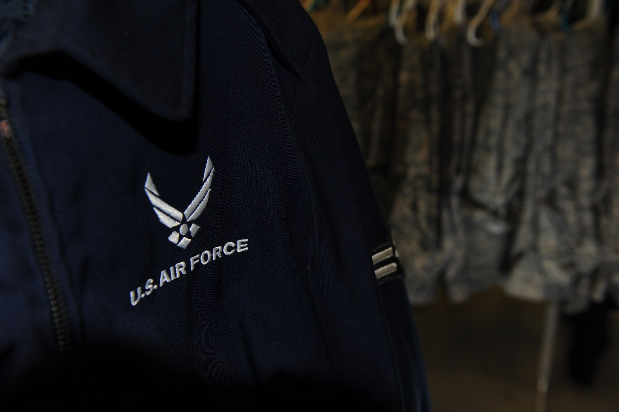 SPANGDAHLEM AIR BASE, Germany – A blues jacket and sets of Airman Battle Uniforms hang in the Airman’s Attic military room. The Airman's Attic’s military room is dedicated to all uniform items including dress blues, ABUs, and Physical Training Uniforms. (U.S. Air Force photo by Master Sgt. Kevin Nichols/Released)