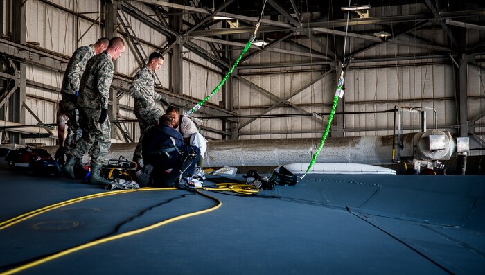Technical Sgt. Anthony Lawston (right), 437th Maintenance Squadron aircraft fuel systems apprentice, and Airmen from the 628th Air Base Wing Civil Engineer Squadron fire department extract Airman 1st Class Nicolas McKinney, 437th MXS Aircraft fuel systems apprentice, during a routine training exercise March 7, 2013, at Joint Base Charleston – Air Base, S.C. The exercise tested Airmen’s ability to recover an unconscious Airman from inside a fuel tank of a C-17 Globemaster III. Fuel System Repair Airmen maintain the fuel cells and tanks by removing, repairing and installing the cells and tanks. The Airmen also clean the cells and tanks, inspect for corrosion, cell deterioration, fungus and foreign objects. (U.S. Air Force photo / Airman 1st Class Tom Brading)