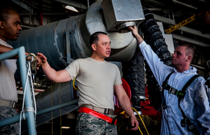 Technical  Sgt. Sam Gordon (center), 437th Maintenance Squadron aircraft fuel systems section chief, gives direction to Senior Airman Brett Jones (left), 437th MXS aircraft fuel systems journeyman and Airman 1st Class Nicolas McKinney (right), 437th MXS aircraft fuel systems apprentice, moments before a training exercise March 7, 2013, at Joint Base Charleston – Air Base, S.C.  Fuel System Repair Airmen maintain the fuel cells and tanks by removing, repairing and installing the cells and tanks. The Airmen also clean the cells and tanks, inspect for corrosion, cell deterioration, fungus and foreign objects. (U.S. Air Force photo / Airman 1st Class Tom Brading)