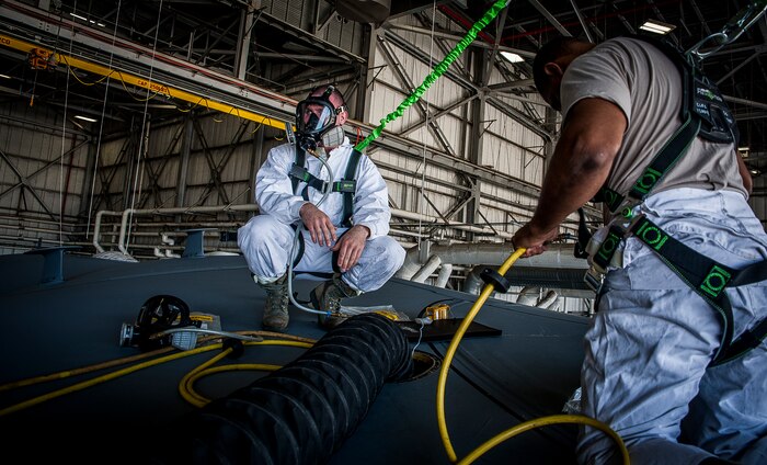 Airman 1st Class Nicholas McKinney (left), 437th Maintenance Squadron aircraft fuels systems apprentice, and Tech. Sgt. Anthony Lawston (right), 437th MXS aircraft fuels system craftsman, make final preparations prior to an exercise March 7, 2013, at Joint Base Charleston – Air Base, S.C.  Fuel System Repair Airmen maintain the fuel cells and tanks by removing, repairing and installing the cells and tanks. The Airmen also clean the cells and tanks, inspect for corrosion, cell deterioration, fungus and foreign objects. (U.S. Air Force photo / Airman 1st Class Tom Brading)