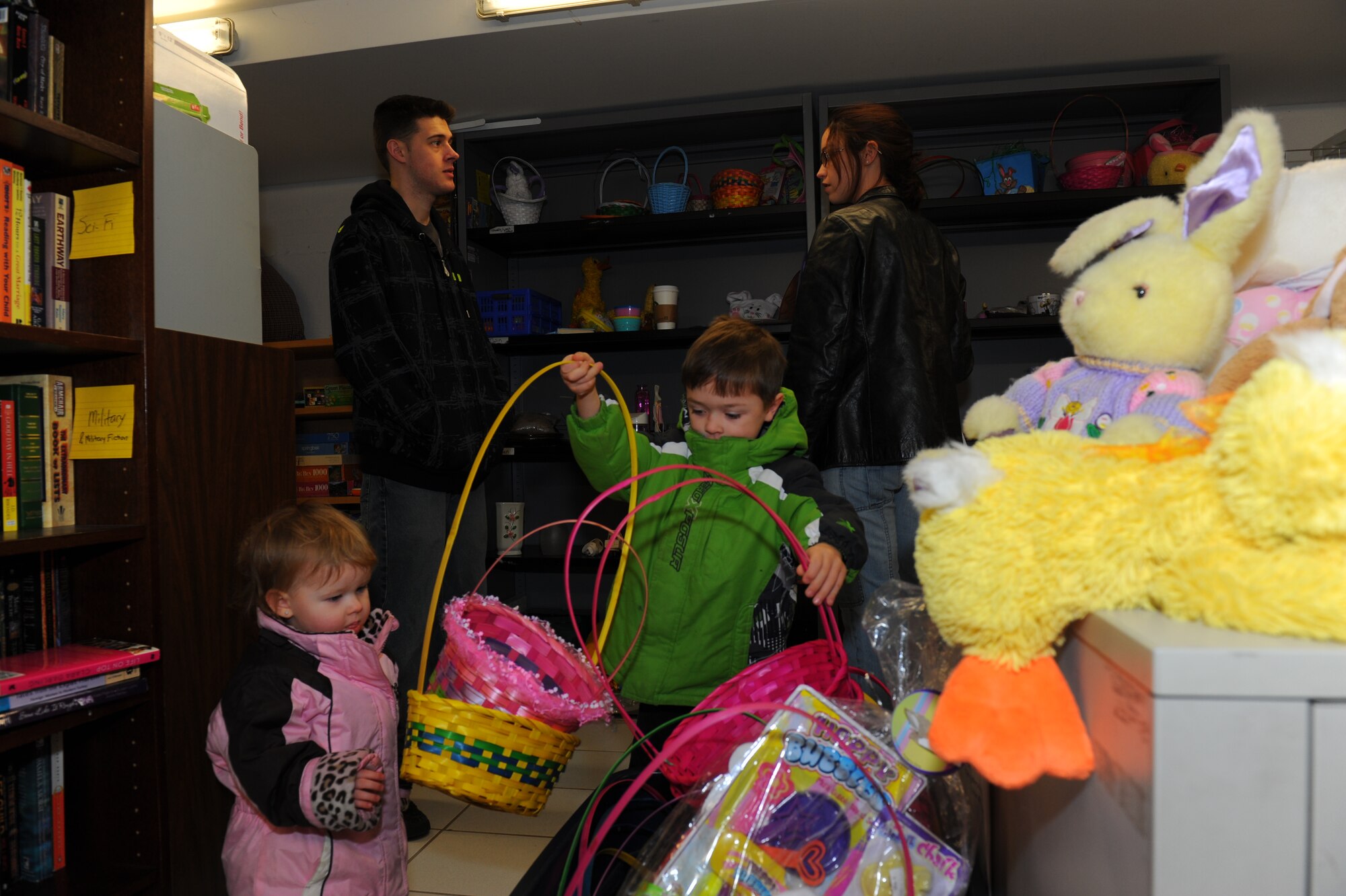 SPANGDAHLEM AIR BASE, Germany – (from front left to right) Gemma Heffelfinger, and her brother Nathan, look at Easter baskets at the Airman’s Attic while shopping with their parents (back left to right) Staff Sgt. Ian Heffelfinger, 52nd Component Maintenance Squadron, and his wife, Meghan. The Airman’s Attic carries a number of different items including seasonal donations. (U.S. Air Force photo by Master Sgt. Kevin Nichols/Released)