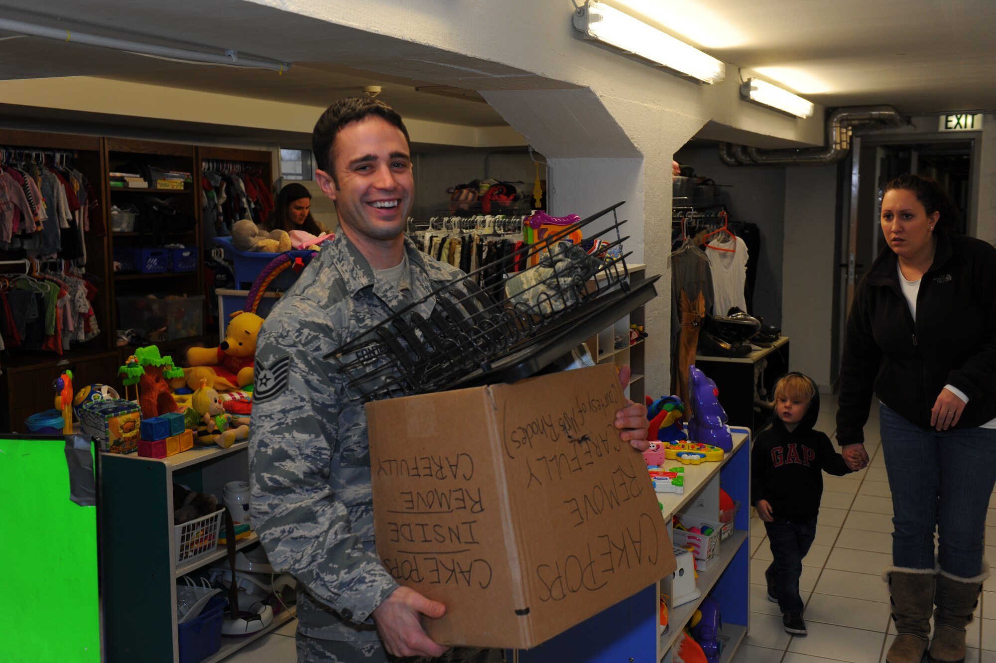 SPANGDAHLEM AIR BASE, Germany – Tech. Sgt. Brandon Fontaine, 52nd Aircraft Maintenance Squadron crew chief from Erie, Pa., carries a box full of dishes and kitchenware Feb. 28. The Airman’s Attic is open to all active-duty ranks and civilian equivalents. (U.S. Air Force photo by Master Sgt. Kevin Nichols/Released) 
