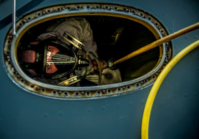 Airman 1st Class Nicholas McKinney, 437th  Maintenance Squadron aircraft fuels systems apprentice, looks up from the inside of a C-17 Globemaster III fuel tank during a routine training exercise March 7, 2013, at Joint Base Charleston – Air Base, S.C.  Fuel System Repair Airmen maintain the fuel cells and tanks by removing, repairing the cells and tanks. The Airmen also clean the cells and tanks, inspect for corrosion, cell deterioration, fungus and foreign objects. (U.S. Air Force photo / Airman 1st Class Tom Brading)