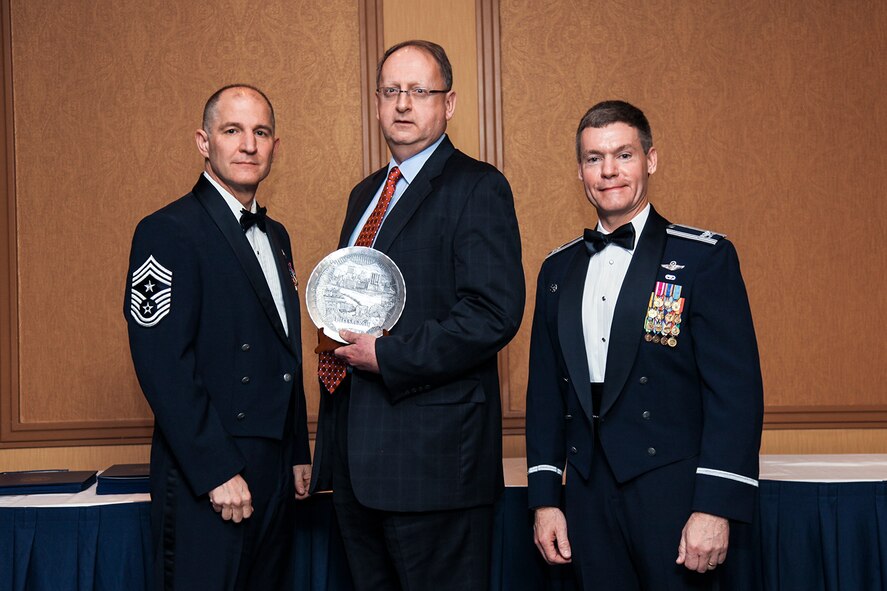 Bradley Penrod (center), Pittsburgh International Airport president and chief strategy officer, receives recognition by 911th Airlift Wing Command Chief Master Sergeant Brian Zator and Col. Craig Peters, 911AW commander during the 911th Airlift Wing Annual Awards Banquet held at the Embassy Suites Hotel in Coraopolis Pa., March 3, 2013. The 911 AW expressed appreciation to Mr. Penrod and the Pittsburgh International Airport for the continuous support provided over the years.  At a cost of $20,000 annually, the airport offers 24/7 runway maintenance, emergency response and fire rescue. (U.S. Air Force photo by Tech. Sgt. Ralph Van Houtem/Released)