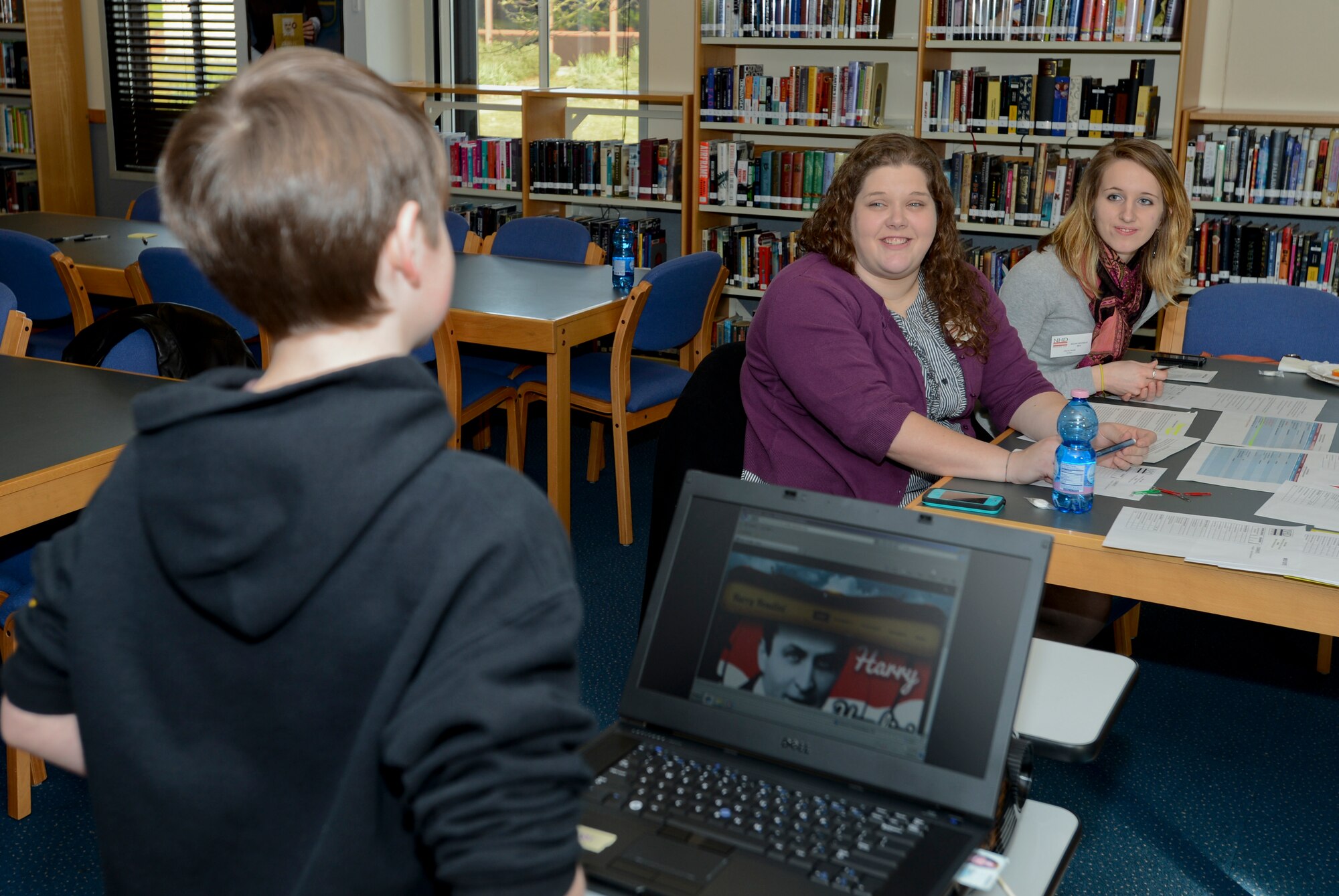 ROYAL AIR FORCE LAKENHEATH, England - (Left to right) Drew Listello, 11, talks to Storey Thompson and Olyvia Smith, showcase judges and Club Beyond leaders at the RAF Lakenheath Chapel, about the website he built describing Harry Houdini during the 2nd Annual Isles District National History Day Showcase Feb. 28, 2013. Students worked individually or in groups of two or three to make projects such as exhibits, documentaries, research papers and websites based on this year's showcase theme, "Turning Points in History." (U.S. Air Force photo by Staff Sgt. Stephen Linch)