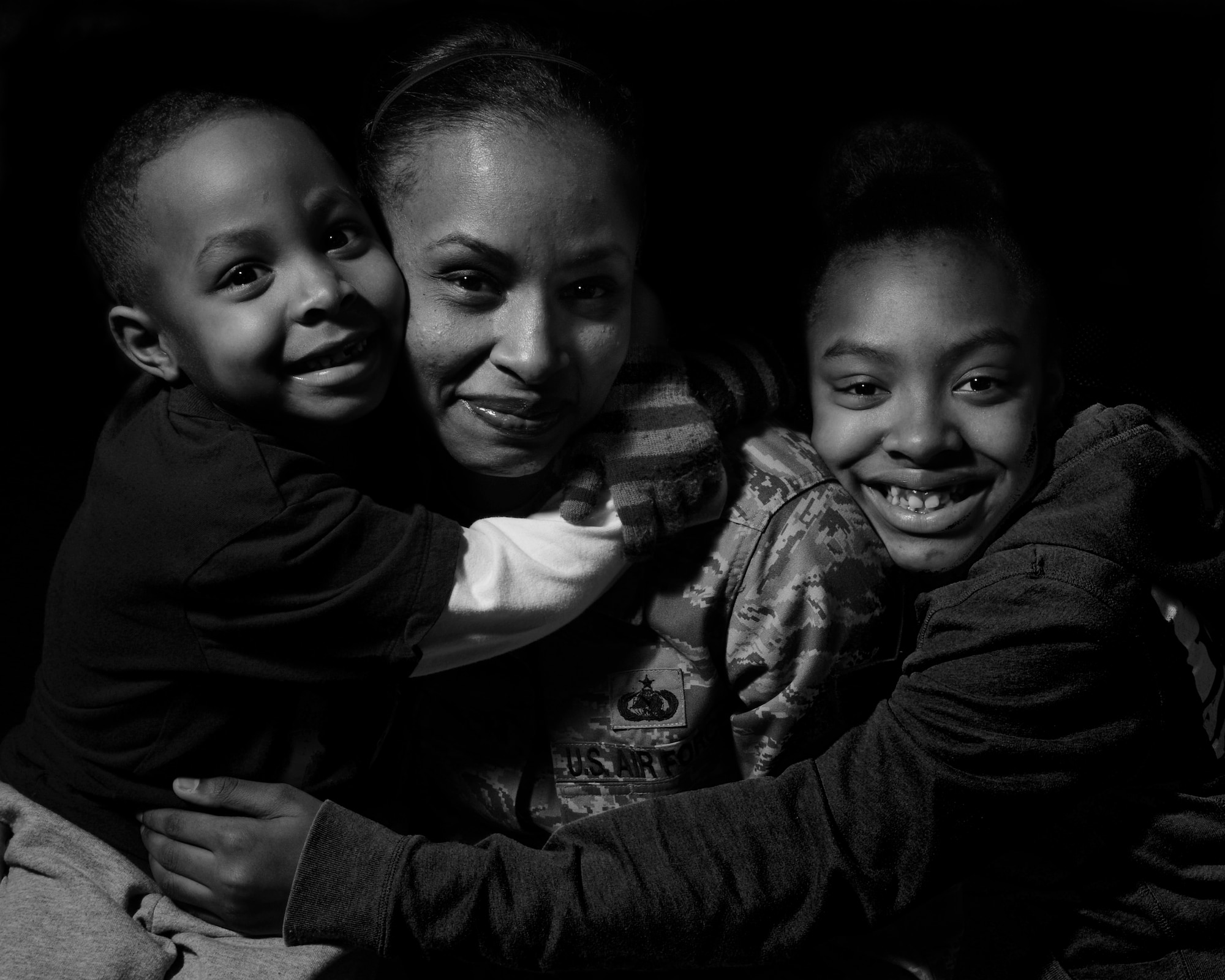 ROYAL AIR FORCE LAKENHEATH, England - Tech. Sgt. Tanya Evans, 48th Logistics Readiness Squadron Traffic Management Office receiving and inbound NCO in charge, and her two kids Marquis and Tierra pose for a photo March 11, 2013.  Evans story of overcoming domestic abuse is one of several being featured during Womens' History Month. (U.S. Air Force photo by Staff Sgt. Stephanie Mancha)