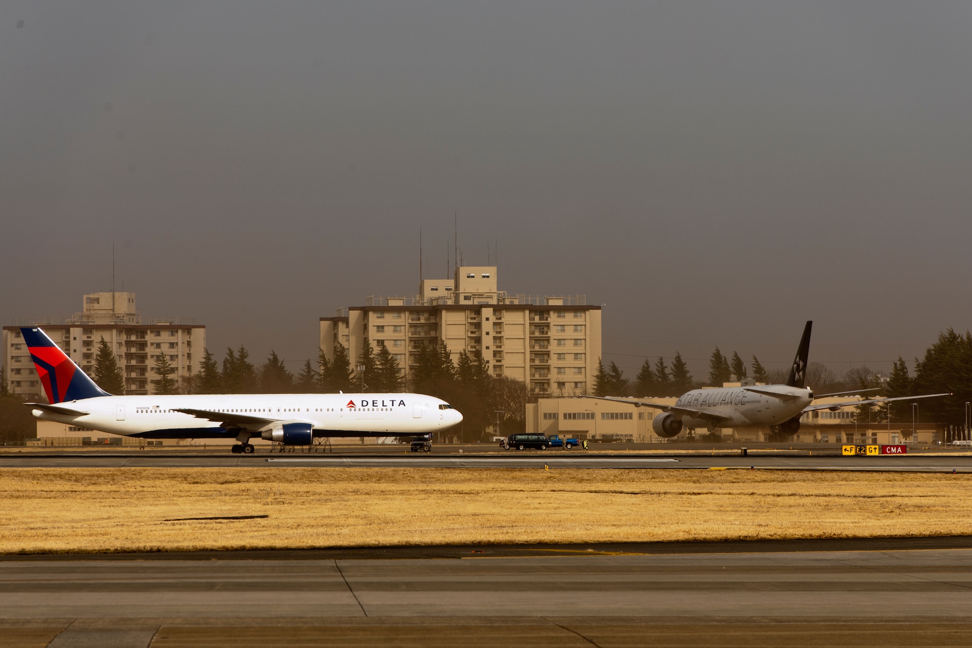 YOKOTA AIR BASE, Japan -- Two commercial aircraft diverted to Yokota Air Base from Narita International Airport, March 13, 2013. Narita IAP experienced peak gusts of 42 knot-cross winds with only 1,500-meter visibility.  Yokota received three commercial aircraft.  (U.S. Air Force photo by Osakabe Yasuo)