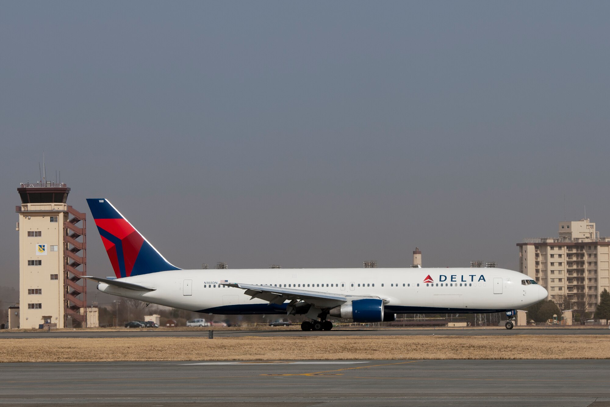 YOKOTA AIR BASE, Japan -- A Delta Airlines flight lands at Yokota Air Base, Japan, March 13, 2013, after diverting from Narita International Airport, Tokyo, Japan. Narita IAP received peak gusts of 42 knot-cross winds with only 1,500-meter visibility. (U.S. Air Force photo by Osakabe Yasuo) 