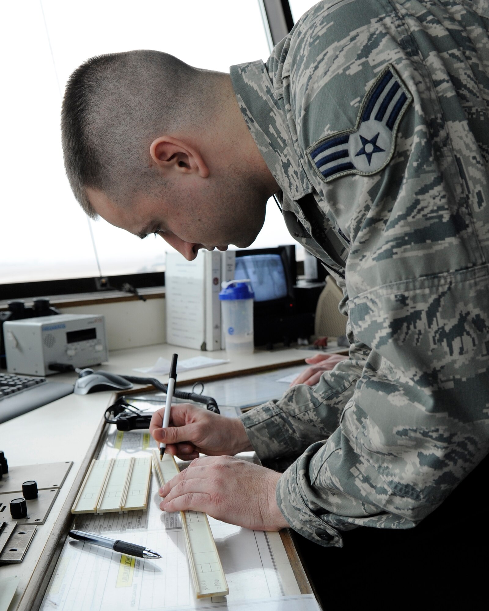 KUNSAN AIR BASE, Republic of Korea – Senior Airman Aaron Lynde, 8th Operations Support Squadron air traffic control journeyman, fills out departure information on a flight strip for an F-16 Fighting Falcon mission at Kunsan Air Base, Republic of Korea, March 12, 2013. The 8th OSS recently won the Pacific Air Force’s 2012 Airfield Operations Flight Complex of the Year Award. (U.S. Air Force photo by Staff Sgt. Tong Duong)