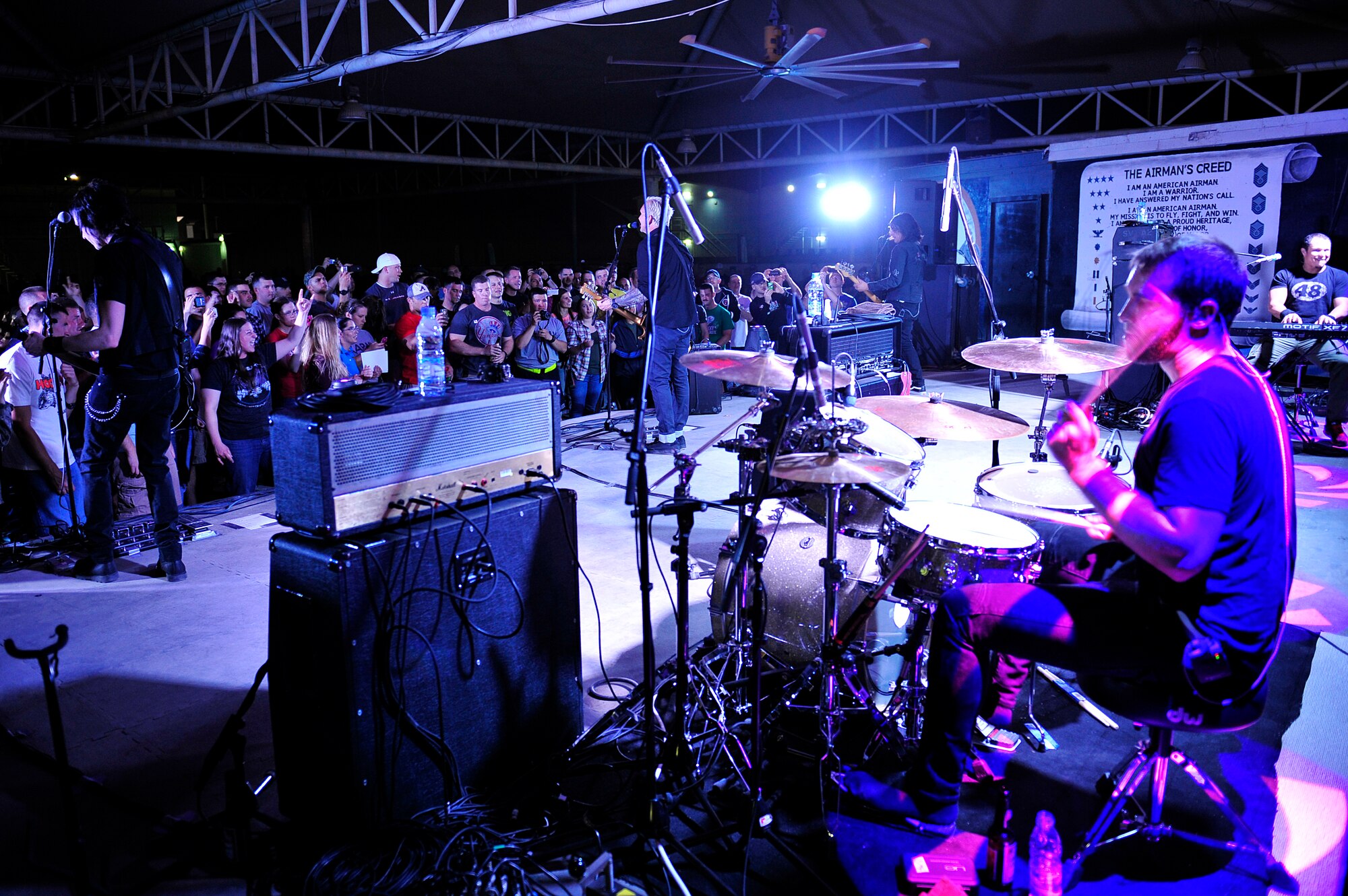 The American rock band Everclear performs a concert for the men and women of the 380th Air Expeditionary Wing at an undisclosed location in Southwest Asia Mar. 10, 2013. Band members spent the day touring the installation and meeting Airmen and Soldiers, thanking them for their sacrifice and service. (U.S. Air Force photo by Tech. Sgt. Christina M. Styer/Released)