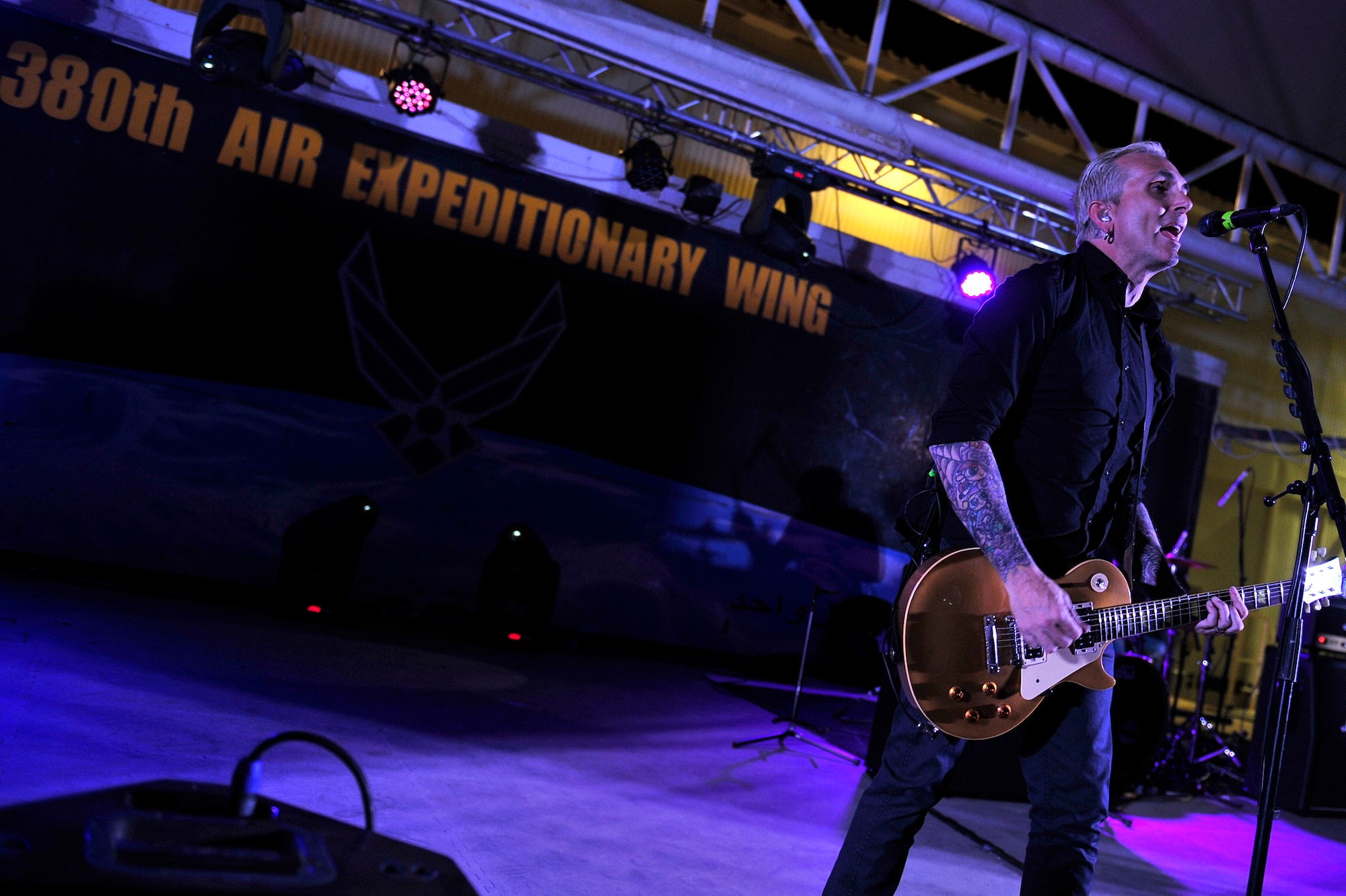Lead singer of the American rock band Everclear performs a concert for the men and women of the 380th Air Expeditionary Wing at an undisclosed location in Southwest Asia Mar. 10, 2013. Band members spent the day touring the installation and meeting Airmen and Soldiers, thanking them for their sacrifice and service. (U.S. Air Force photo by Tech. Sgt. Christina M. Styer/Released)