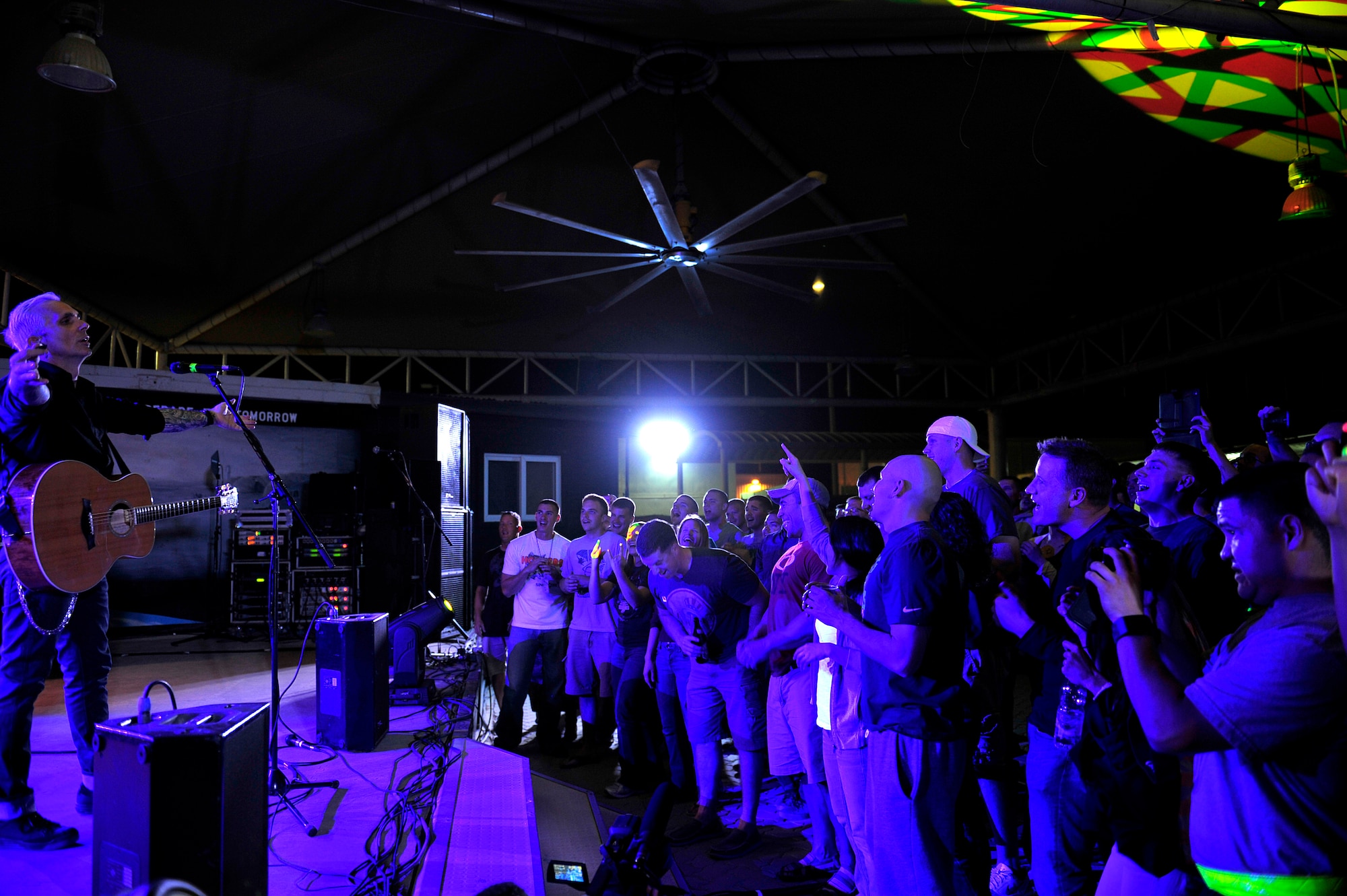 Lead singer of the American rock band Everclear performs a concert for the men and women of the 380th Air Expeditionary Wing at an undisclosed location in Southwest Asia Mar. 10, 2013. Band members spent the day touring the installation and meeting Airmen and Soldiers, thanking them for their sacrifice and service. (U.S. Air Force photo by Tech. Sgt. Christina M. Styer/Released)