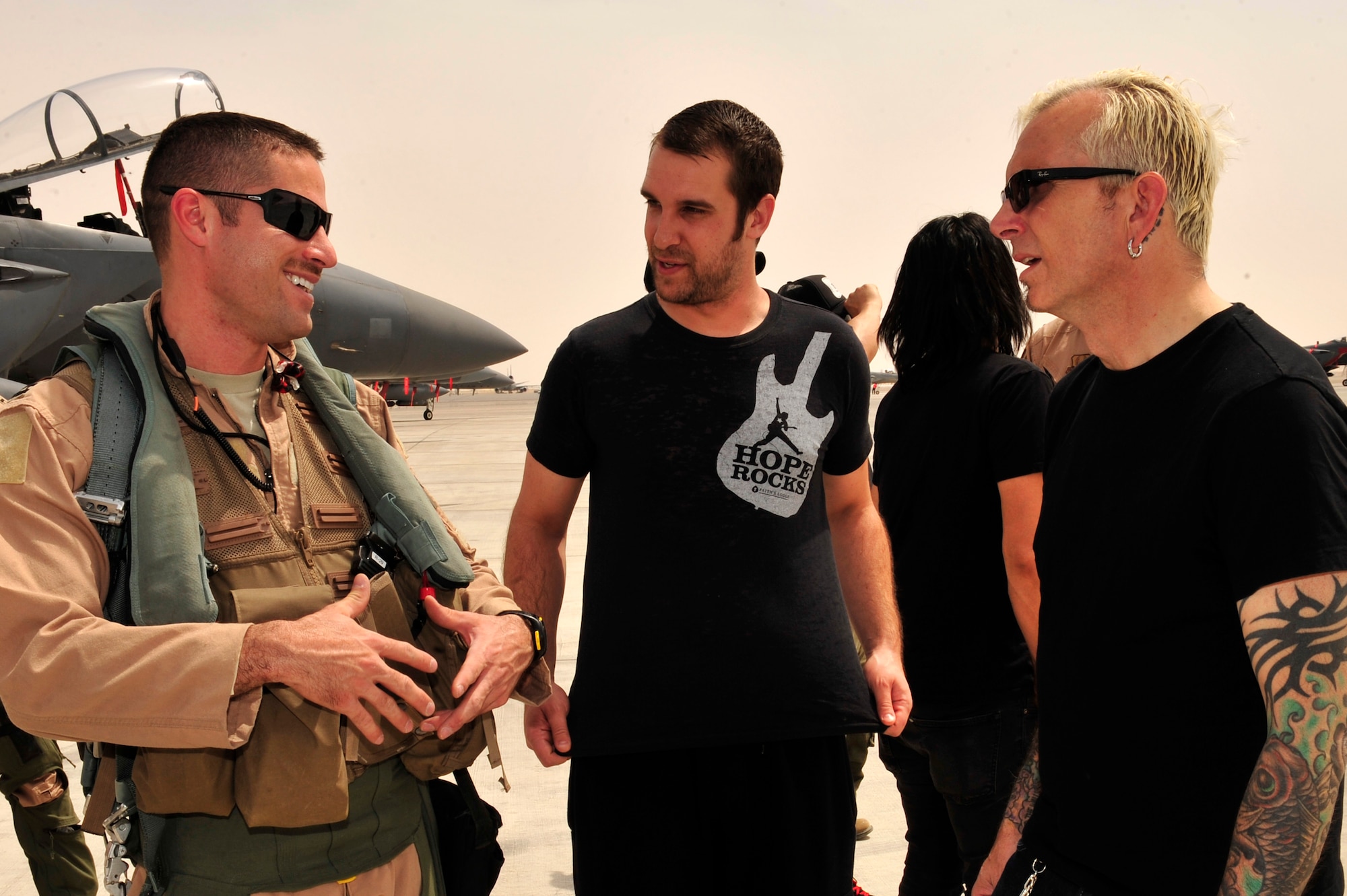 U.S. Air Force Capt. Dave Bentley, 494th Expeditionary Fighter Squadron weapons system officer, deployed from Lakenheath Air Base, England, talks to Everclear band members Art Alexakis, lead vocals, and Sean Winchester, drummer, at an undisclosed location in Southwest Asia Mar. 10, 2013. The American rock band visited Airmen and Soldiers and performed a concert of their greatest hits for the 380th Air Expeditionary Wing. (U.S. Air Force photo by Tech. Sgt. Christina M. Styer/Released) 