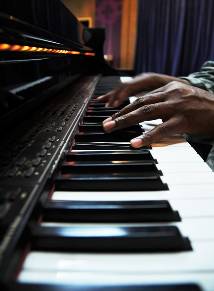 Tech. Sgt. Robert Carter, 7th Air Force knowledge operations NCO in charge, plays a melodic piano riff on the piano at the base chapel March 13, 2013. Carter is a vocalist and plays both the piano and drums. (U.S. Air Force photo/Senior Airman Kristina Overton)